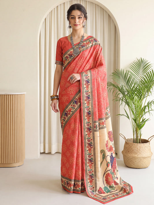 Woman wearing coral silk blend saree with traditional indian motif work and coral blouse