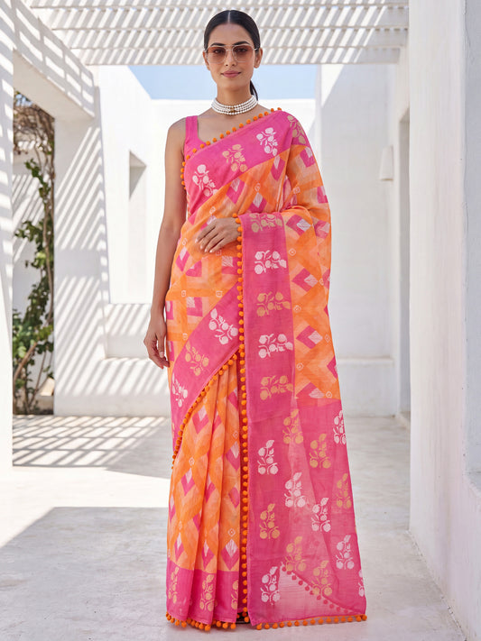 Woman wearing orange cotton saree with chevron zigzag pattern and pink blouse