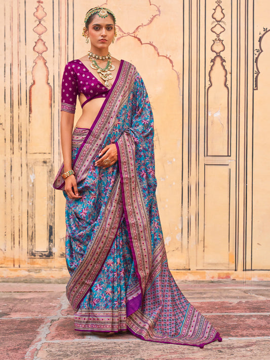 Woman wearing teal blue silk blend saree with kalamkari narrative motif work and purple blouse