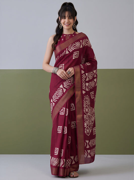 Woman wearing magenta silk blend saree with traditional indian motif work and magenta blouse