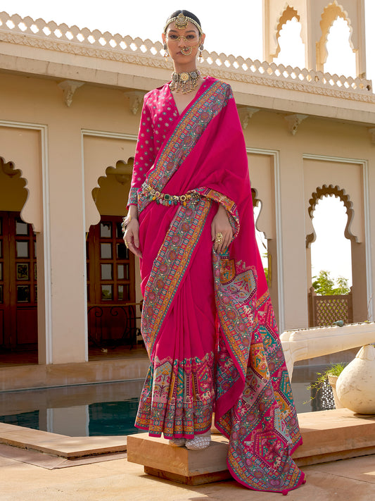 : Rani pink Patola silk saree with elephant and floral motifs, multicolor Patola border and tassels,