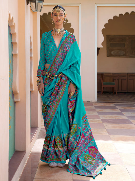 Teal Patola silk saree with elephant and floral motifs, multicolor Patola border and tassels,