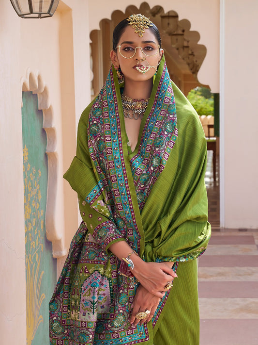 Olive green Patola silk saree with elephant and floral motifs, multicolor Patola border and tassels