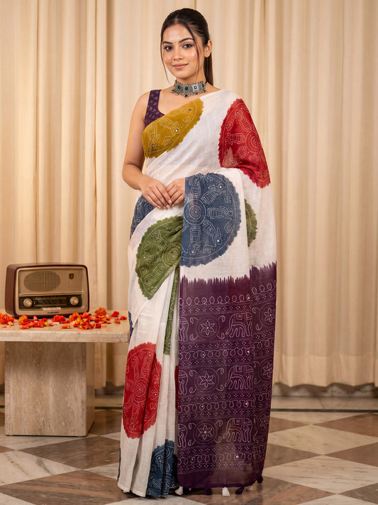 Woman wearing off white linen saree with bandhani tie-dye dot work and wine blouse