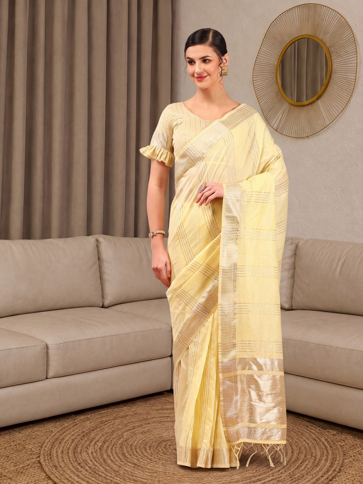 Woman wearing yellow linen saree with zari butta (metallic motif) work and yellow blouse