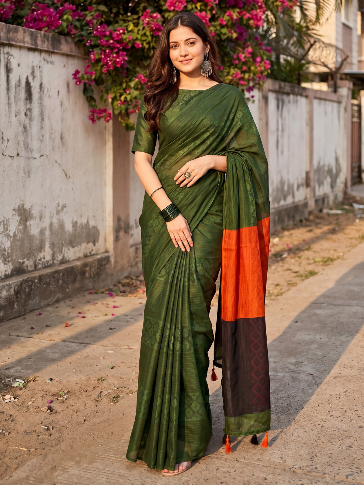 Woman wearing green cotton saree with traditional indian motif work and green blouse