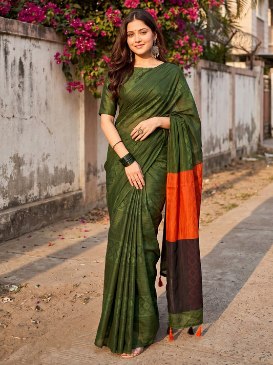 Woman wearing green cotton saree with traditional indian motif work and green blouse