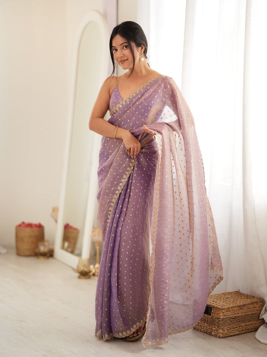 Woman wearing lavender georgette saree with zari butta (metallic motif) work and lavender blouse