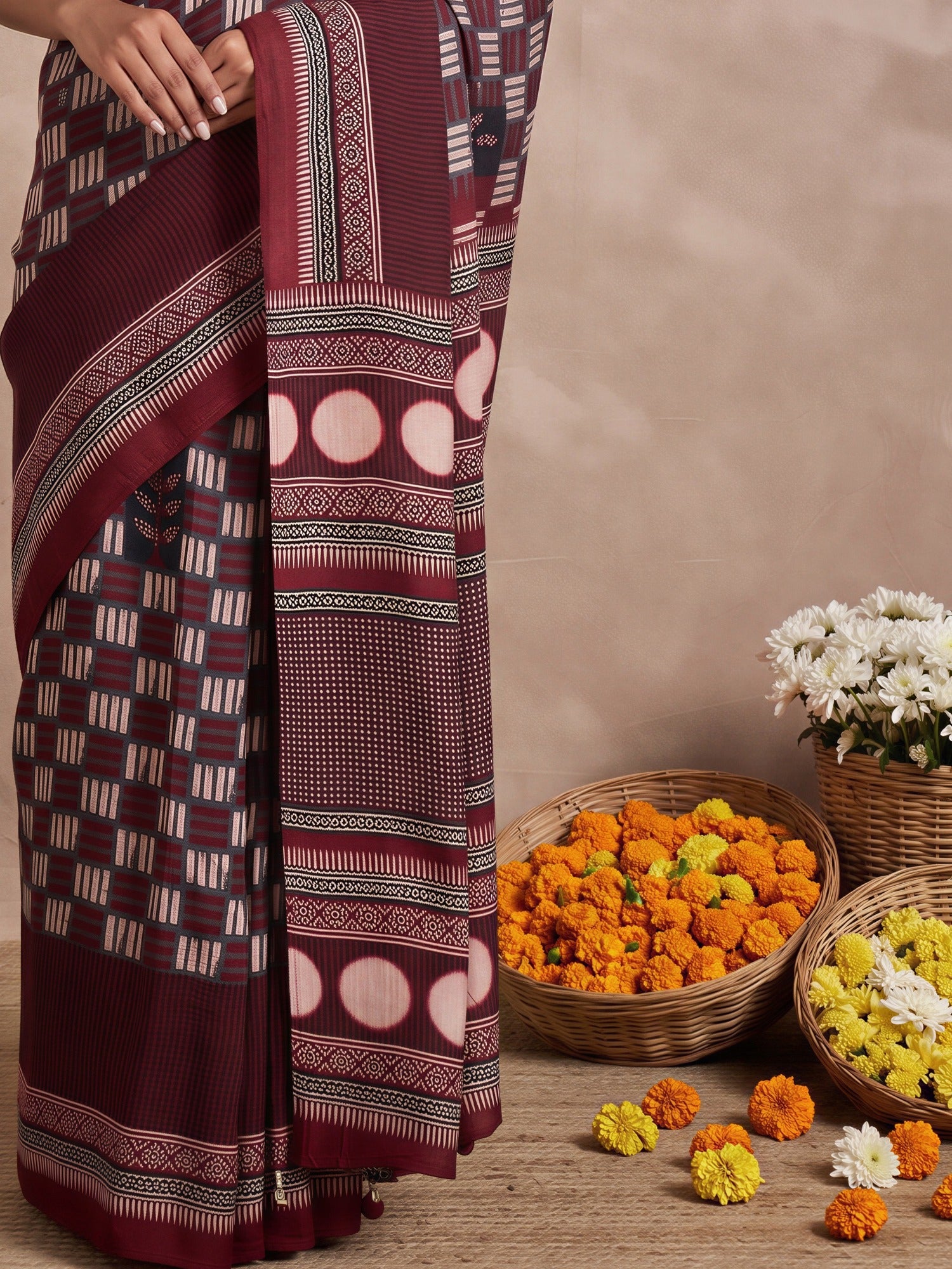 Pallu detail of maroon viscose silk saree showing traditional indian motif work and printed border