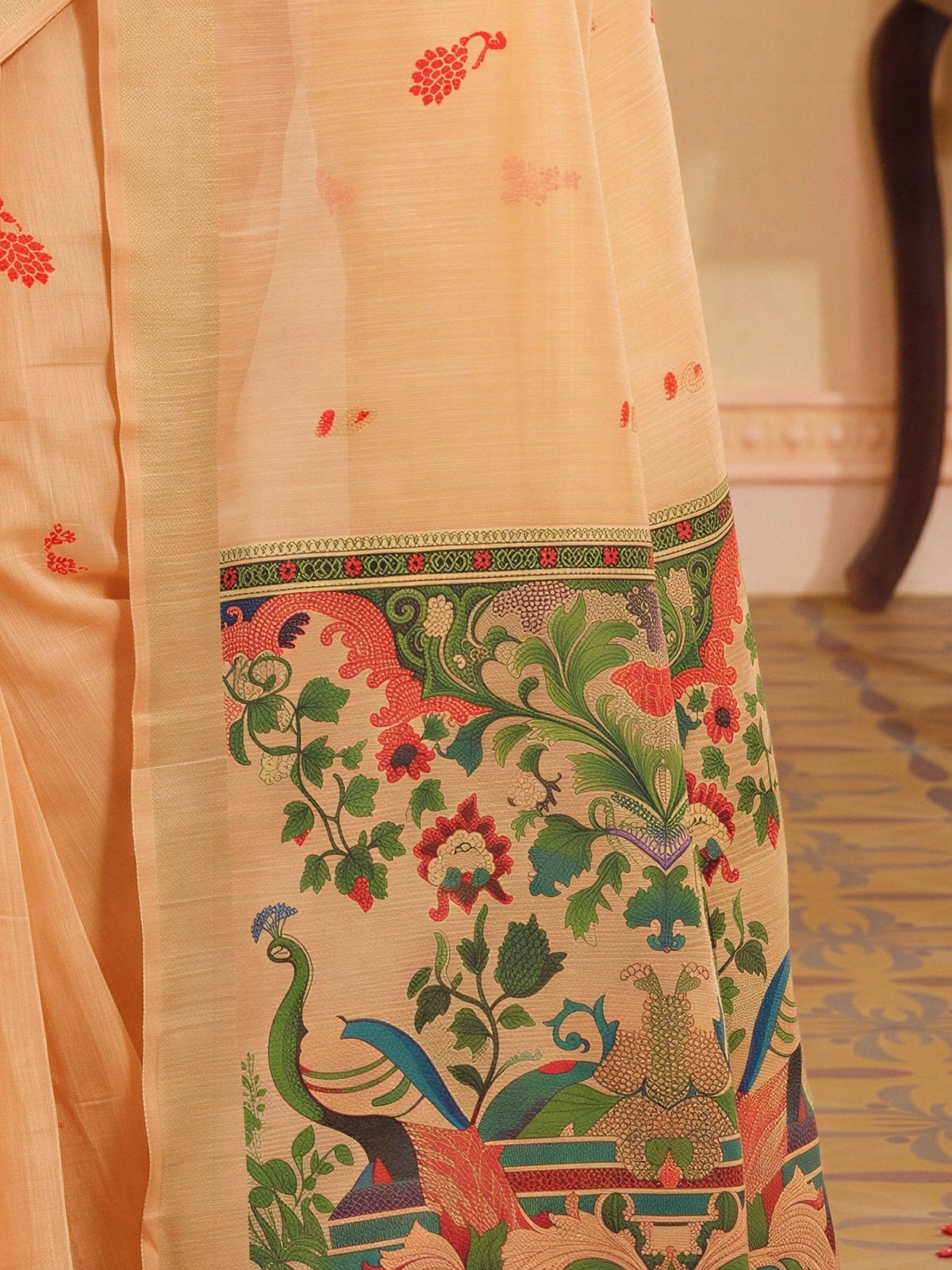 Pallu detail of peach silk blend saree showing traditional indian motif work and zari border