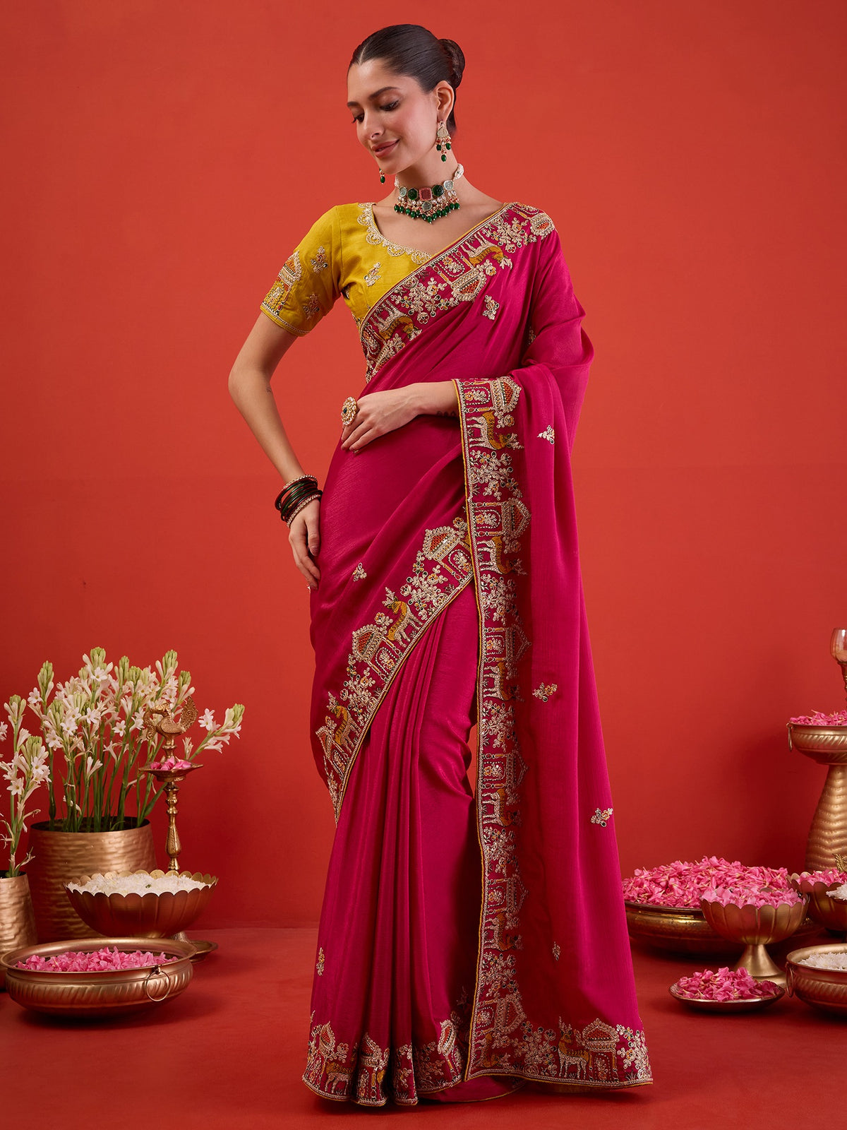Woman wearing pink silk blend saree with embroidered motif work and mustard blouse
