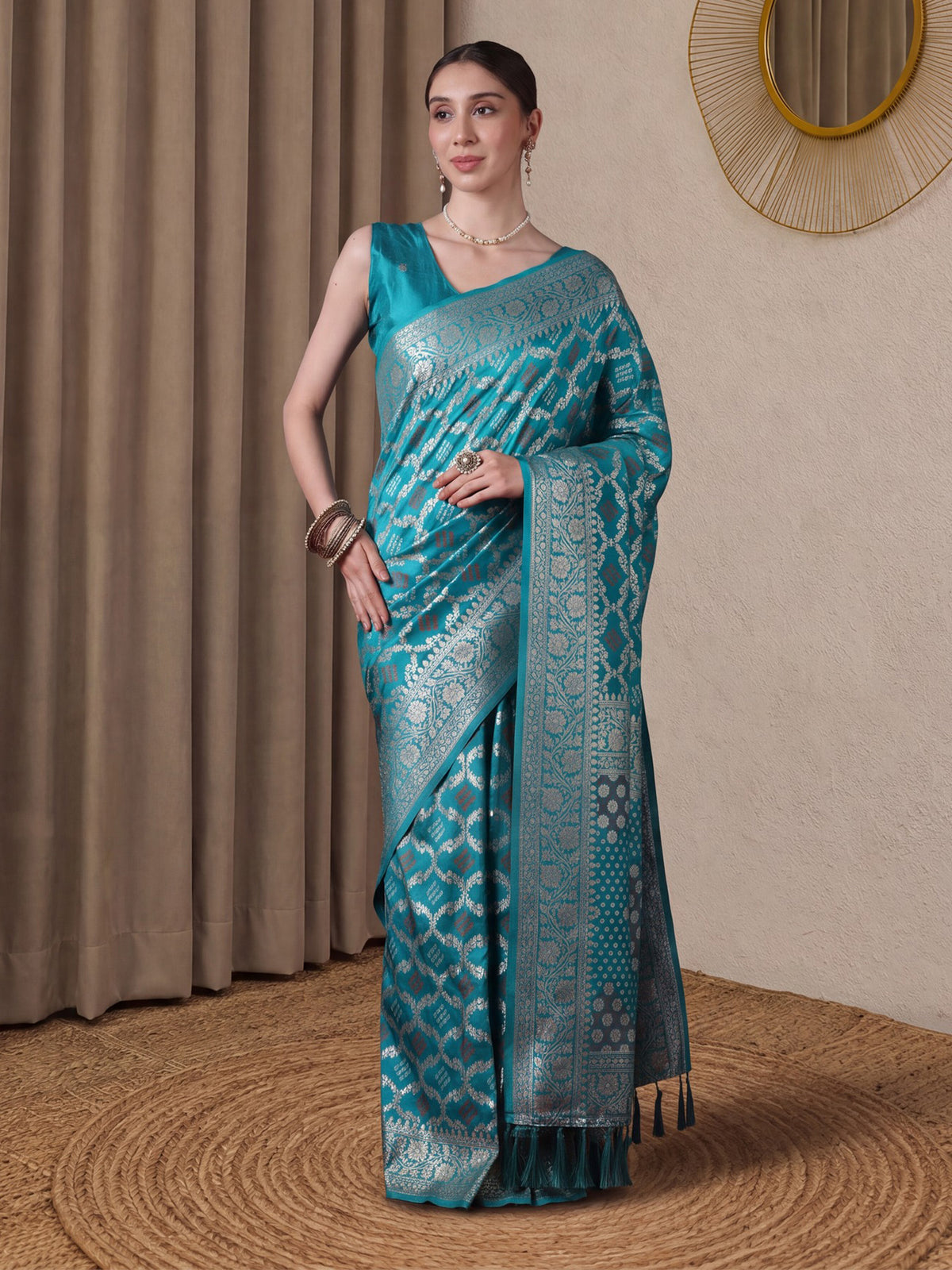 Woman wearing turquoise dola silk saree with bandhani tie-dye dot work and turquoise blouse