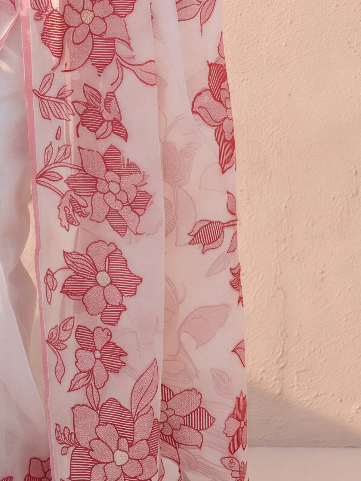 Pallu detail of white cotton linen saree showing traditional indian motif work and woven design border