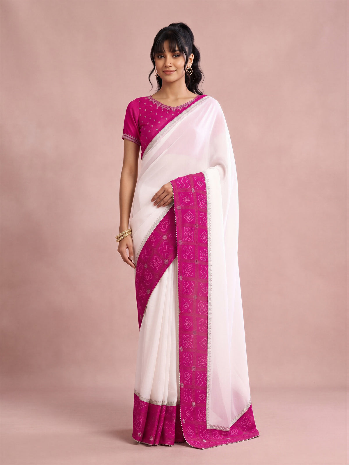 Woman wearing white vichitra silk saree with bandhani tie-dye dot work and pink blouse