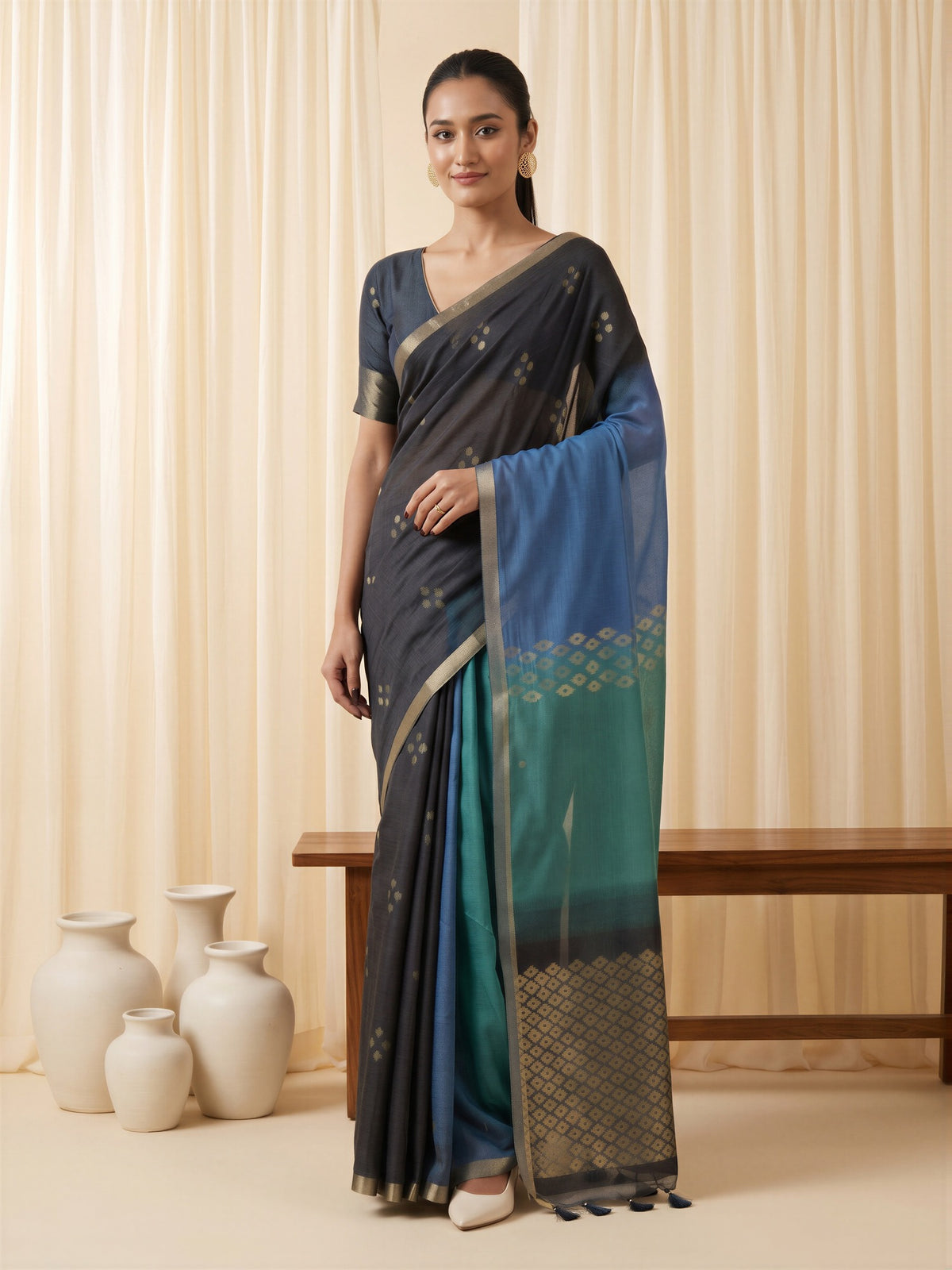 Woman wearing black viscose silk saree with traditional indian motif work and black blouse