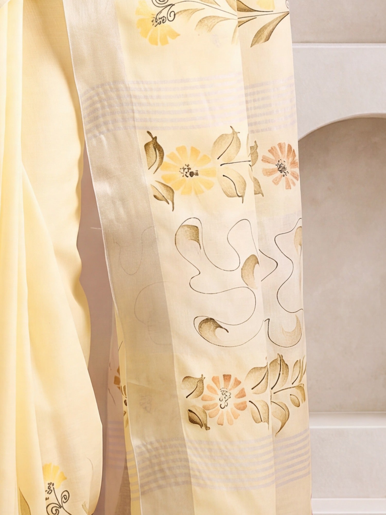 Pallu detail of lemon yellow linen saree showing traditional indian motif work and printed border