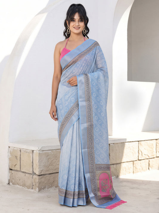 Woman wearing light blue cotton silk saree with traditional indian motif work and pink blouse