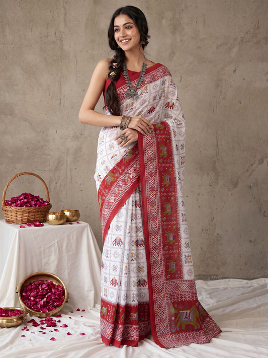 Woman wearing white cotton saree with traditional indian motif work and red blouse
