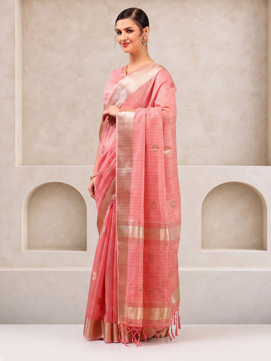 Woman wearing pink linen saree with zari butta (metallic motif) work and pink blouse