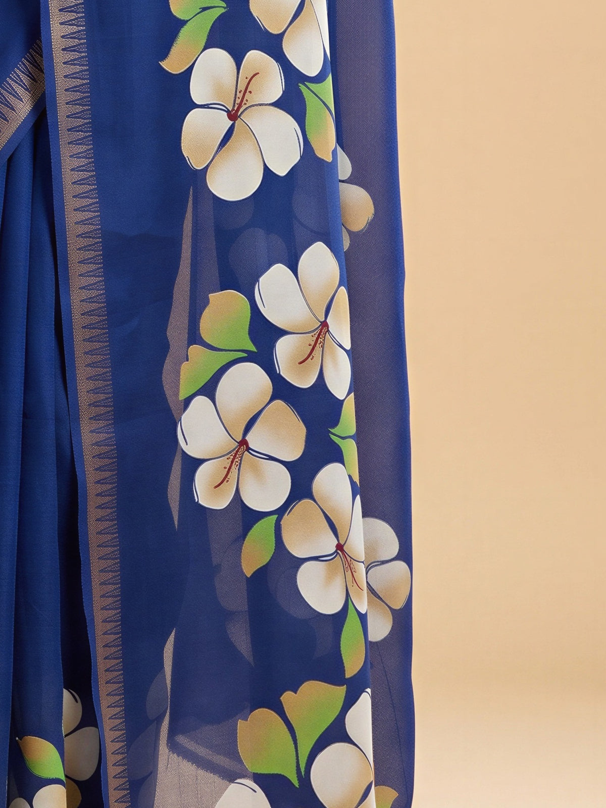 Pallu detail of blue georgette saree showing all-over floral design and zari border