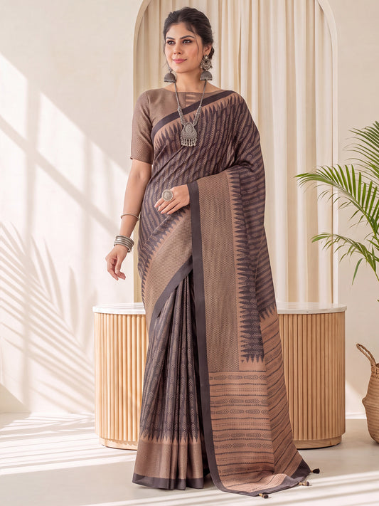 Woman wearing black silk blend saree with traditional indian motif work and tan blouse