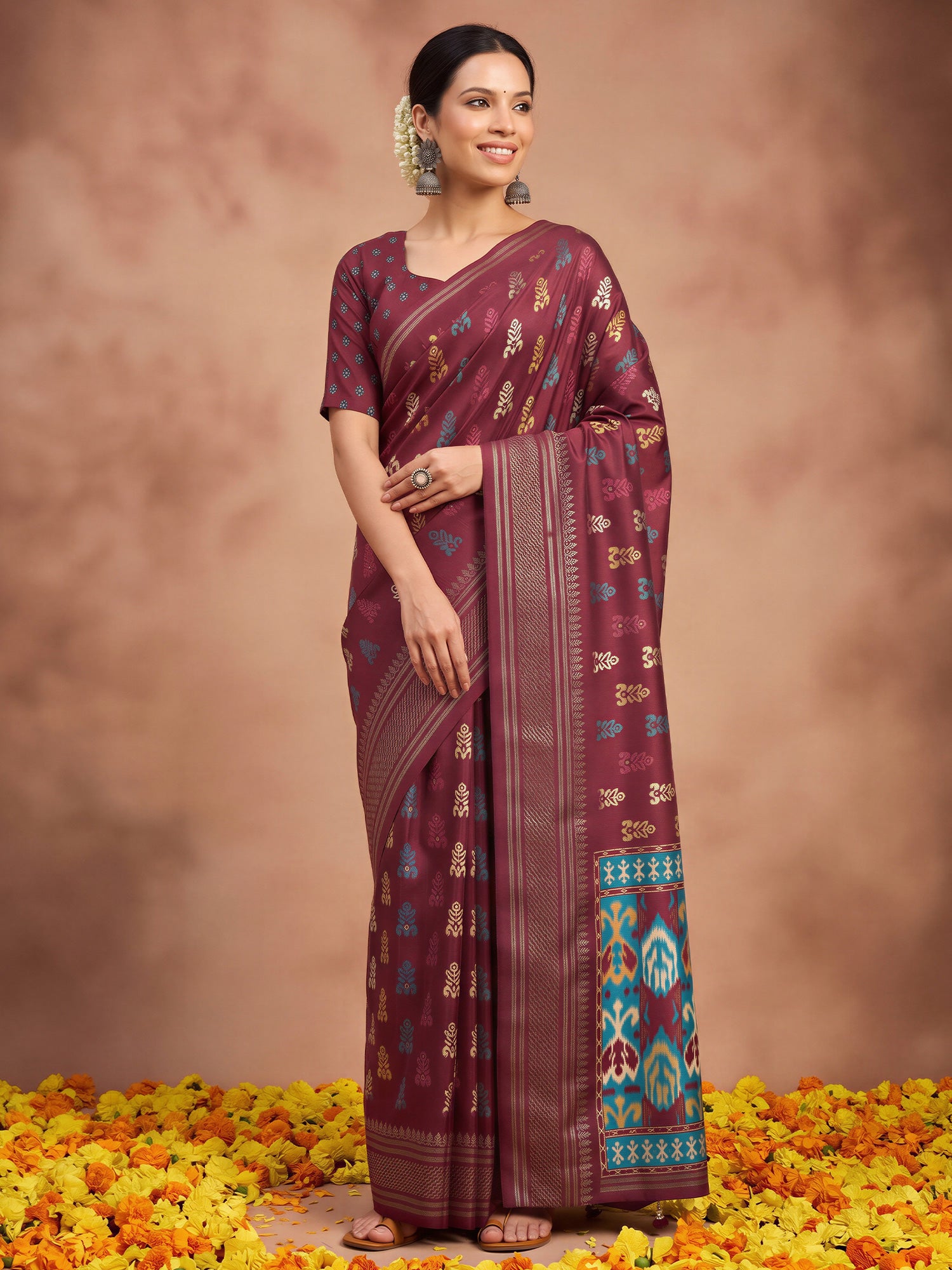 Woman wearing maroon silk blend saree with metallic foil print work and maroon blouse