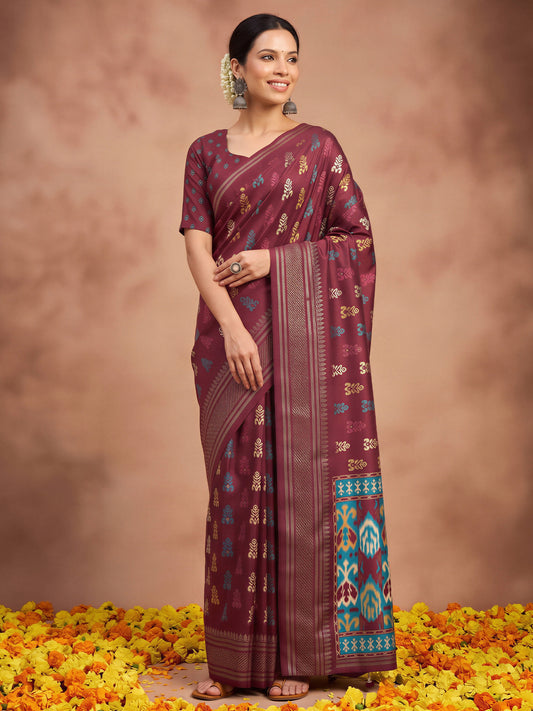 Woman wearing maroon silk blend saree with metallic foil print work and maroon blouse