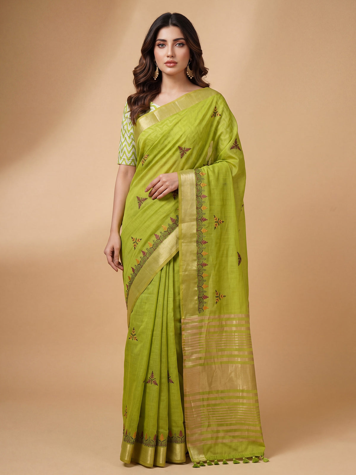 Woman wearing lime green cotton linen saree with embroidered motif work and lime green blouse