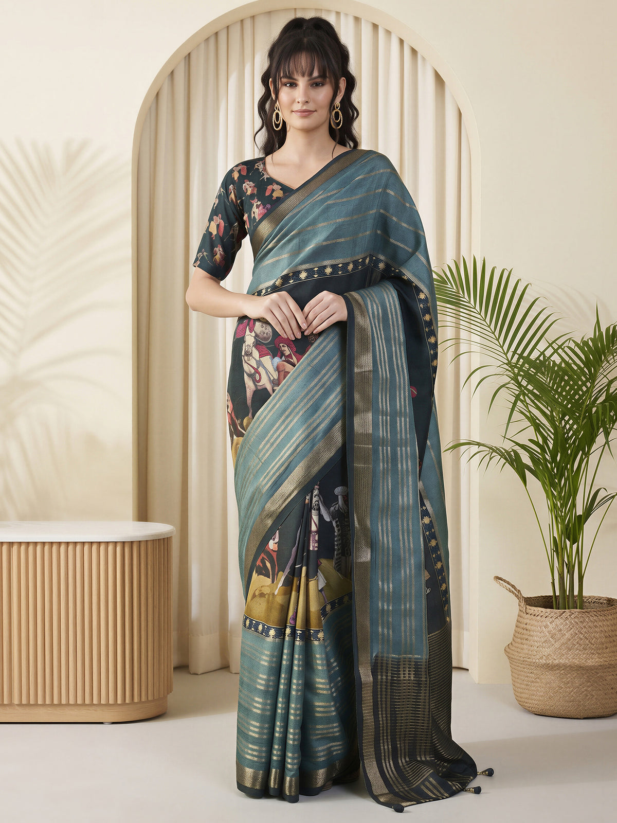 Woman wearing teal blue viscose silk saree with kalamkari narrative motif work and dark blue blouse