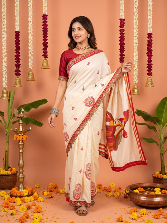 Woman wearing off white cotton saree with traditional indian motif work and red blouse