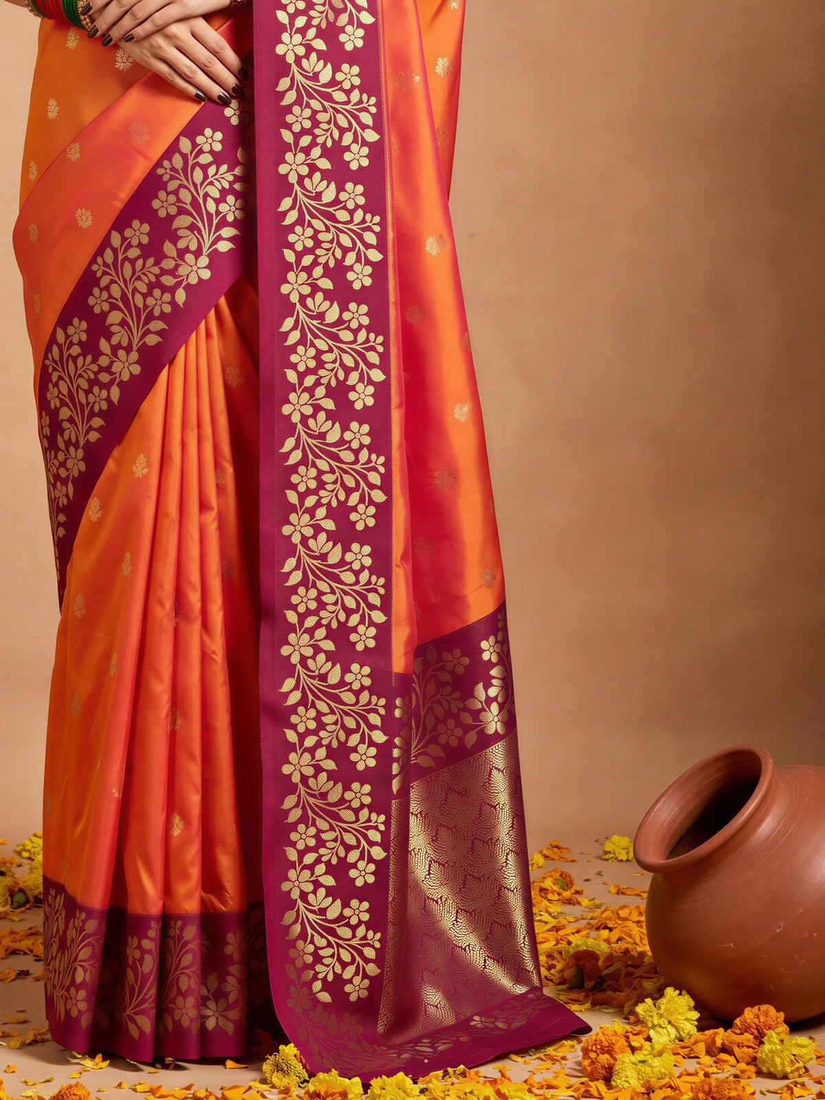 Pallu detail of orange cotton blend saree showing all-over floral design and zari border
