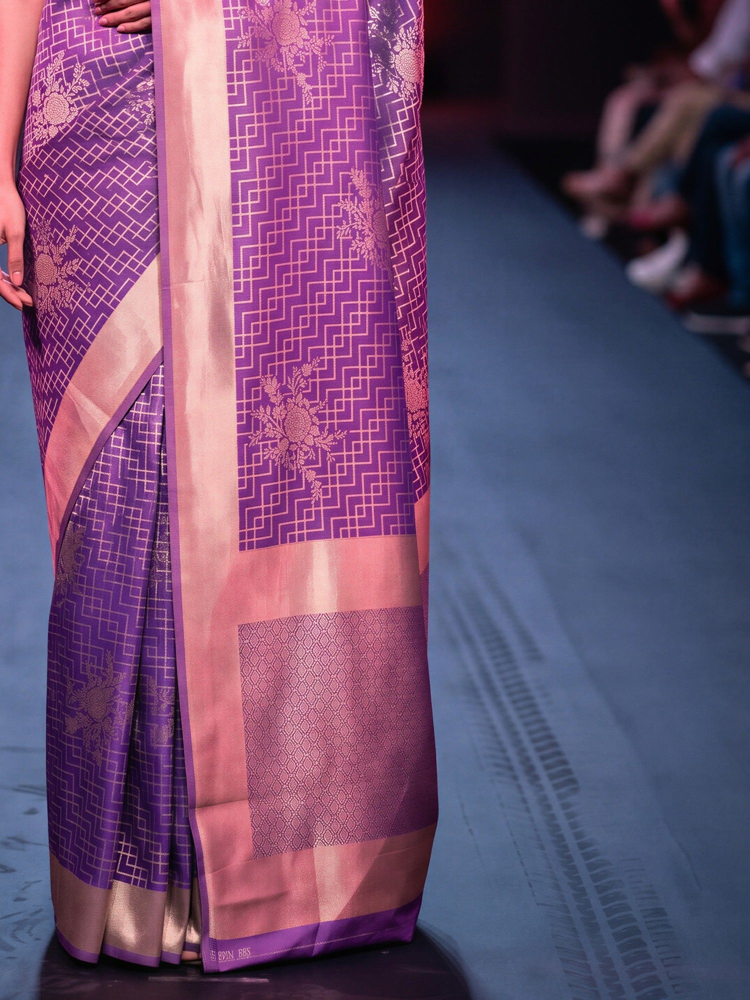 Pallu detail of purple silk blend saree showing zari butta (metallic motif) work and zari border