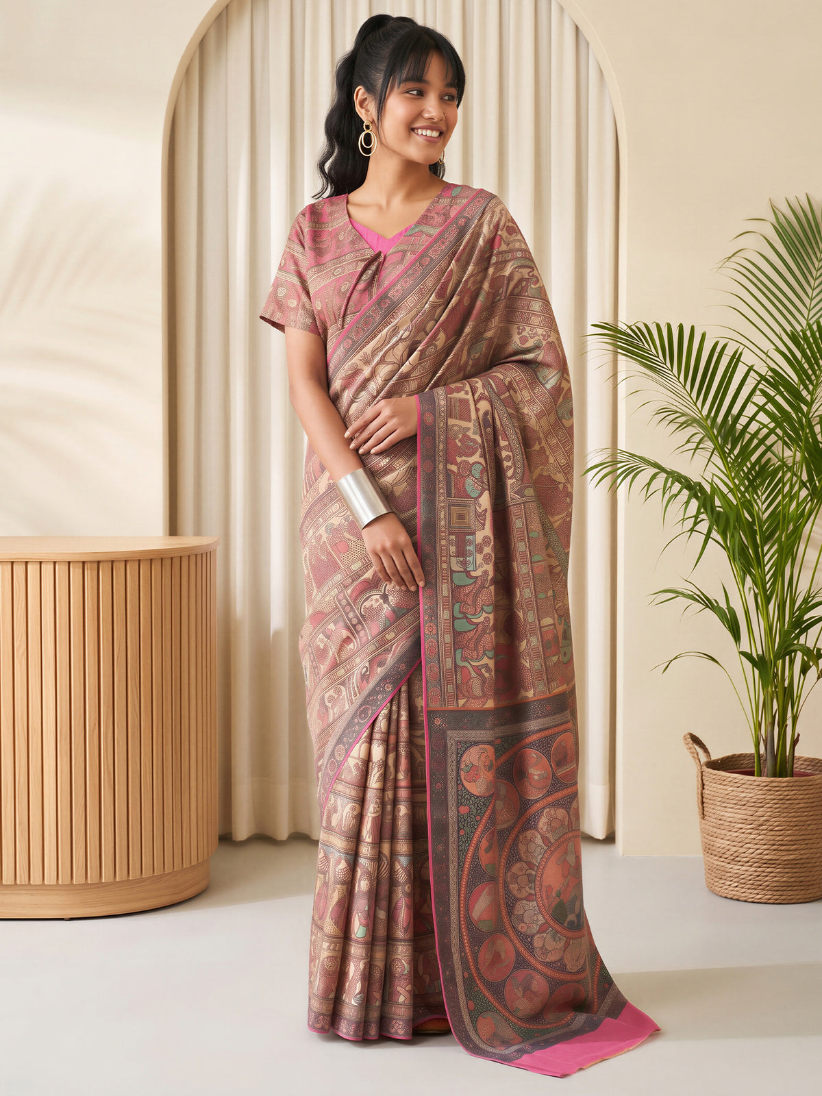 Woman wearing beige silk blend saree with madhubani folk-art motifs and pink blouse