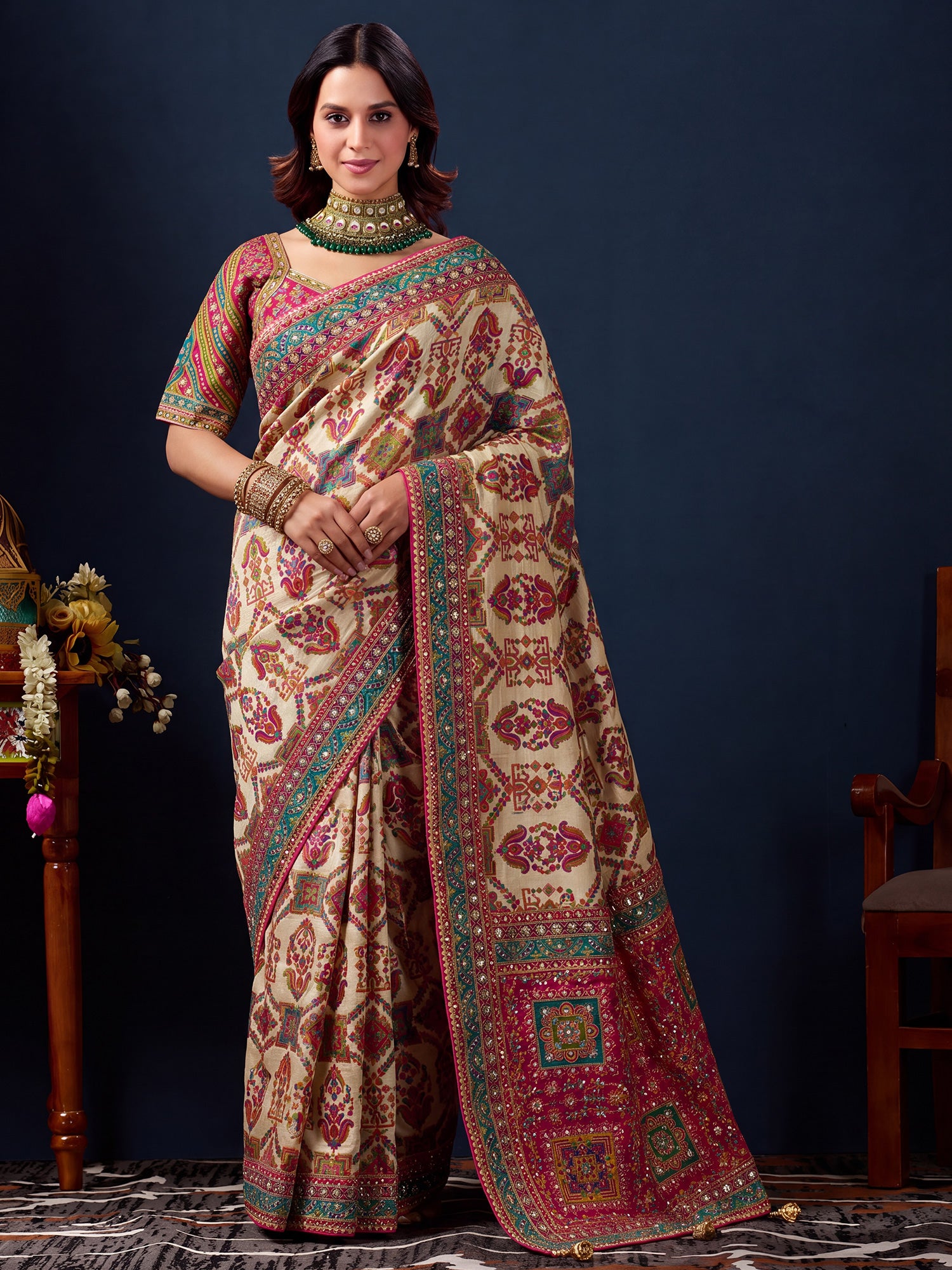 Woman wearing cream silk blend saree with traditional indian motif work and pink blouse