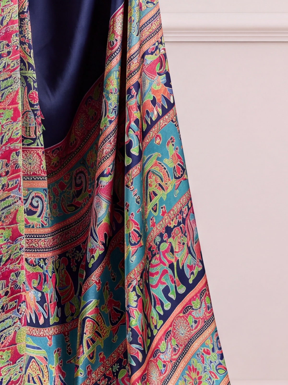 Pallu detail of navy blue satin saree showing madhubani folk-art motifs and printed border