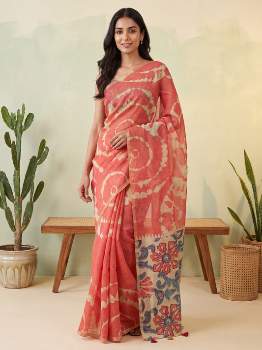 Woman wearing rust cotton linen saree with shibori resist-dye pattern and teal green blouse