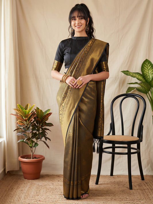 Woman wearing gold silk blend saree with woven motif design and black blouse