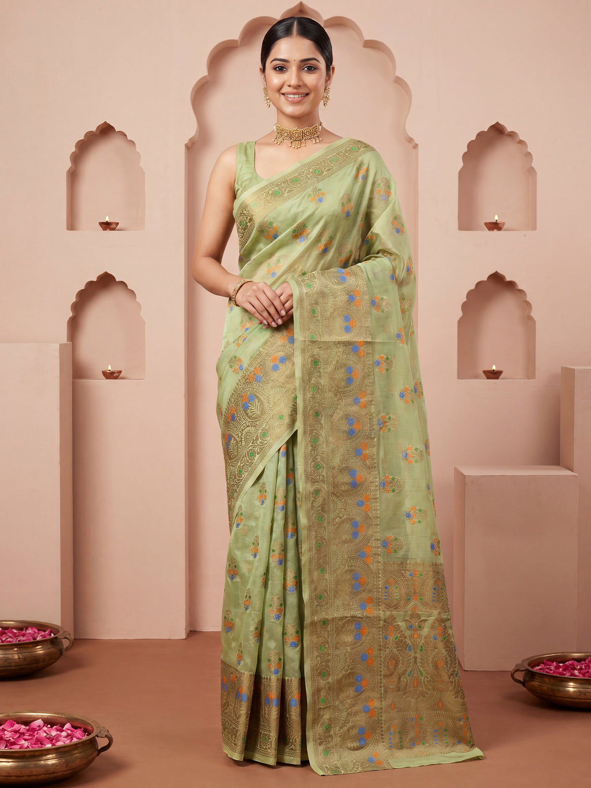 Woman wearing light green silk blend saree with zari butta (metallic motif) work and light green blouse