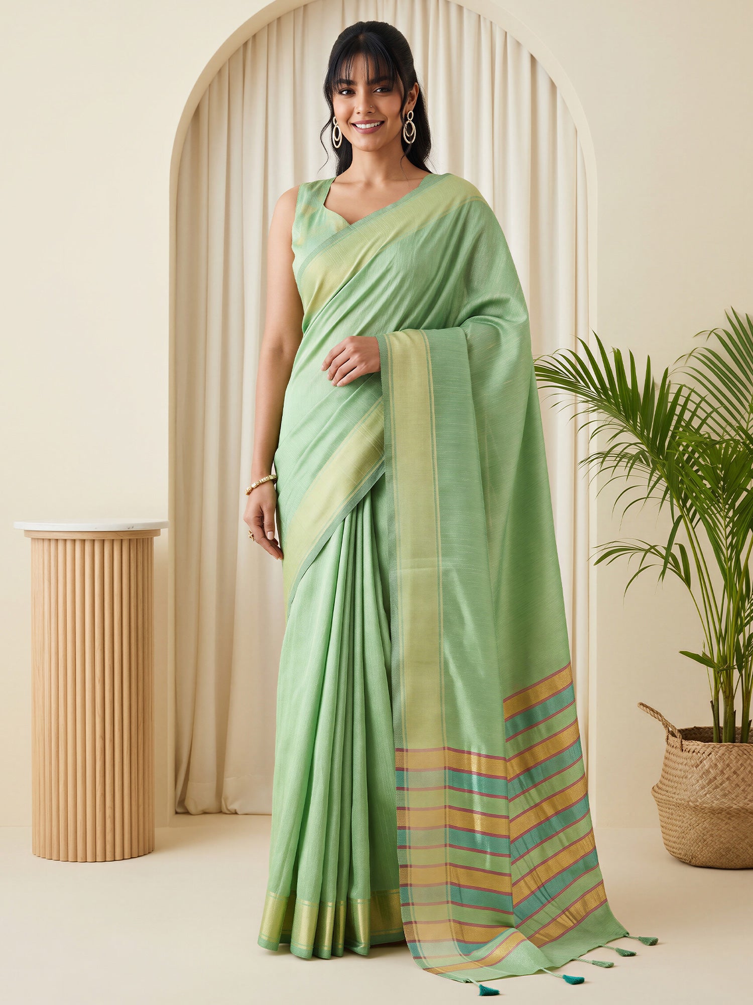 Woman wearing light green bhagalpuri silk saree with traditional indian motif work and light green blouse