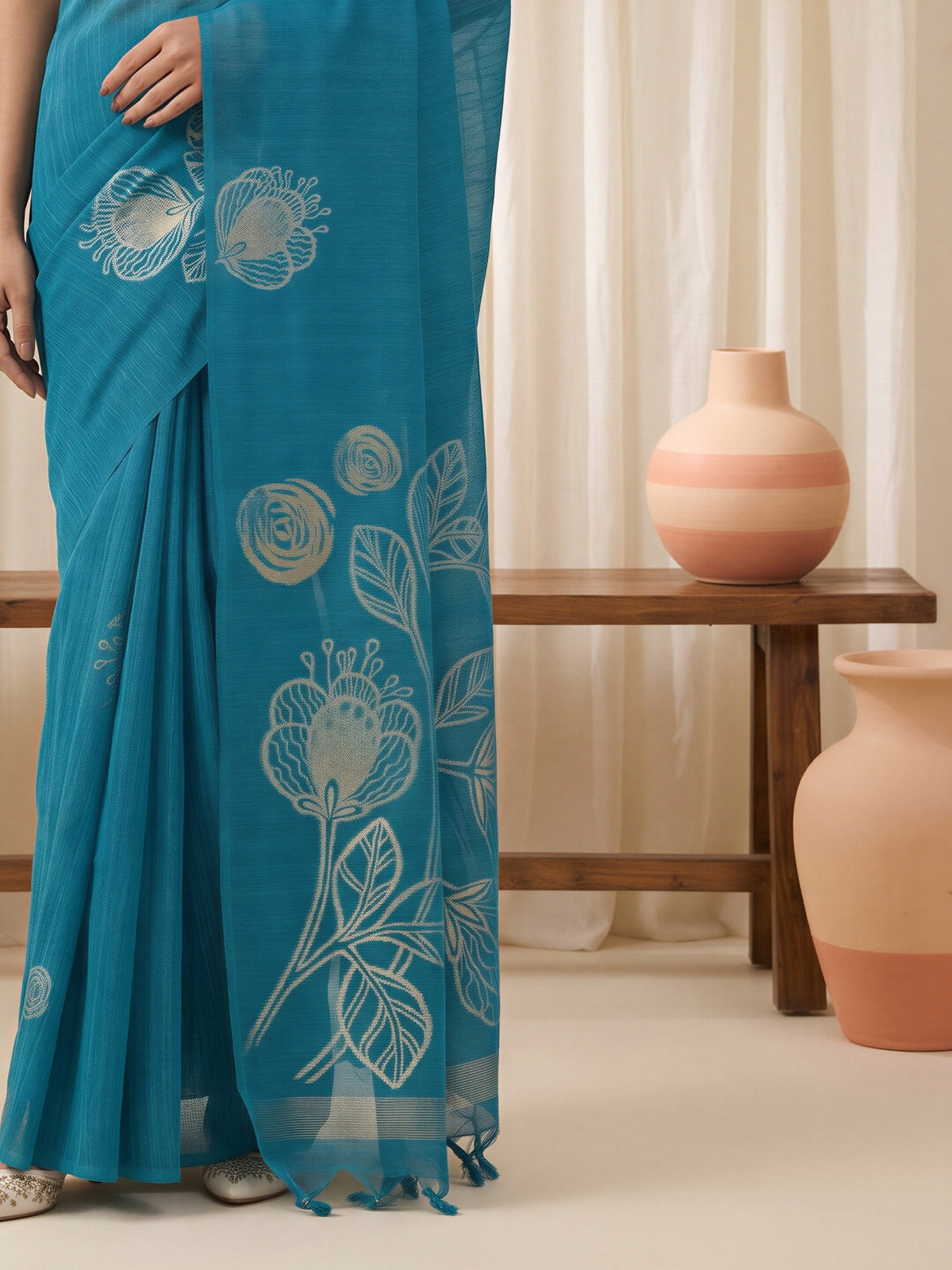 Pallu detail of light blue pure silk saree showing all-over floral design and solid border