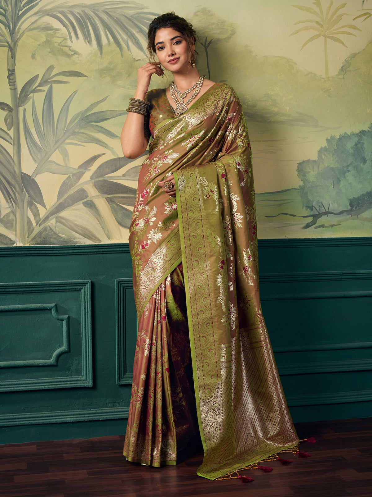 Woman wearing olive banarasi silk saree with woven motif design and olive blouse