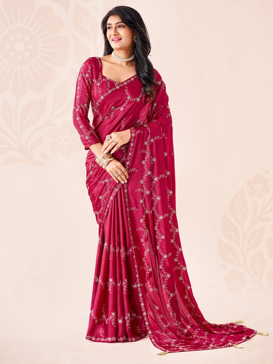 Woman wearing pink chiffon saree with ornamented surface design and pink blouse
