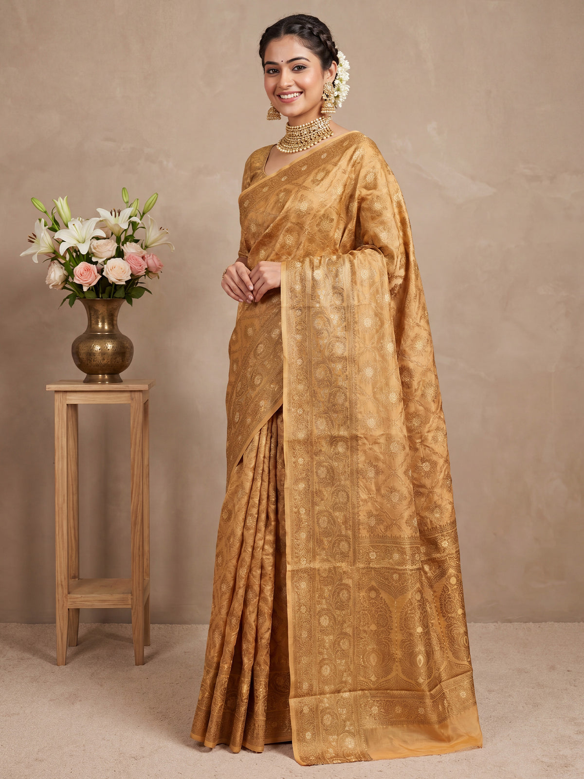 Woman wearing mustard silk blend saree with traditional indian motif work and mustard blouse
