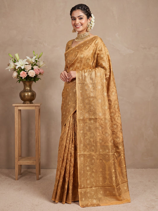 Woman wearing mustard silk blend saree with traditional indian motif work and mustard blouse