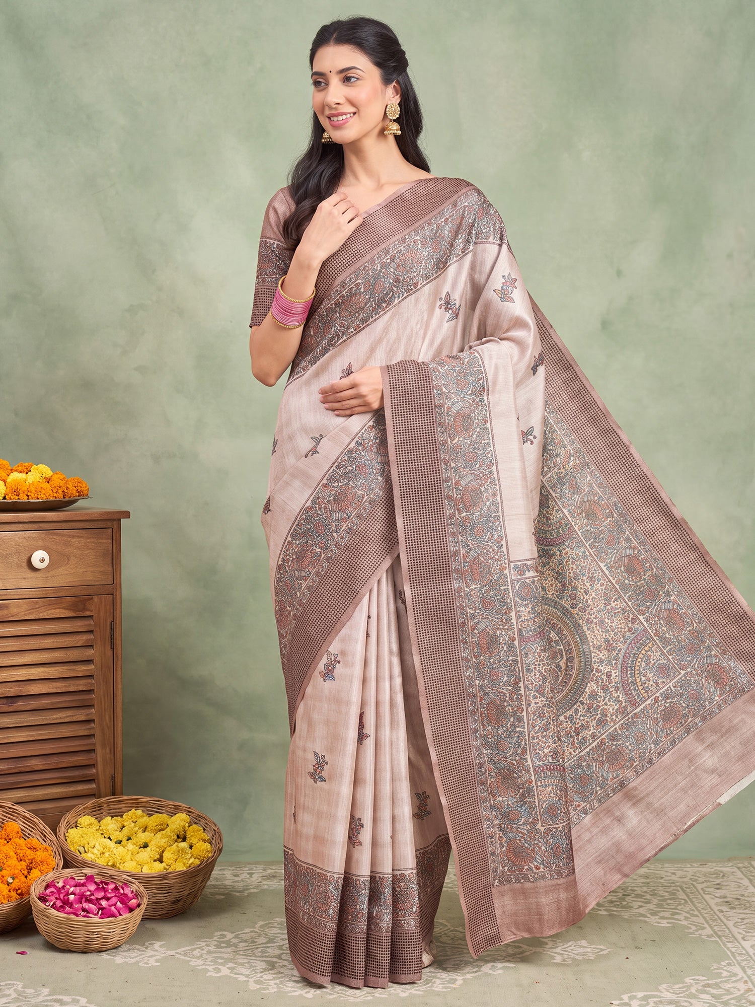 Woman wearing beige manipuri silk saree with madhubani folk-art motifs and beige blouse