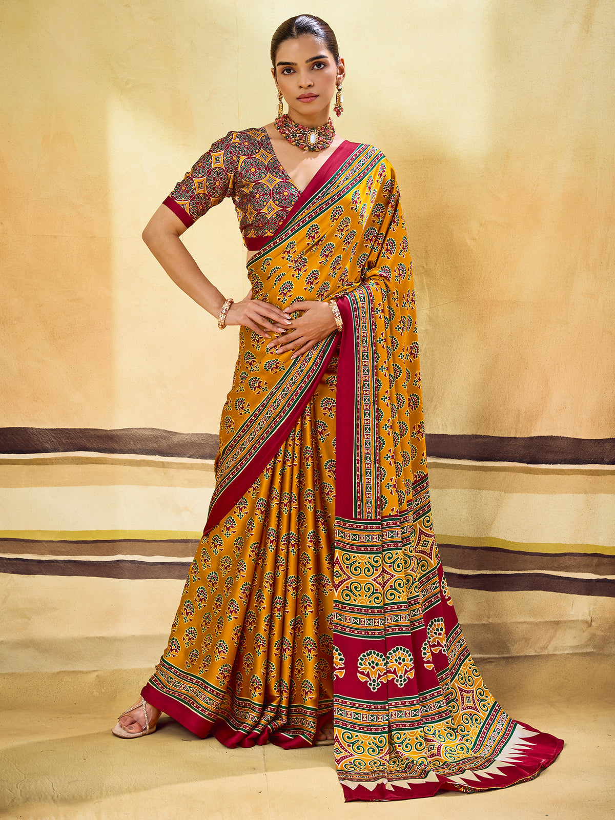 Woman wearing mustard satin saree with ajrak block-print motif work and mustard blouse