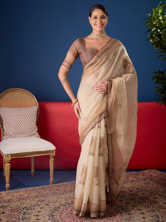 Woman wearing beige cotton blend saree with zari butta (metallic motif) work and light brown blouse