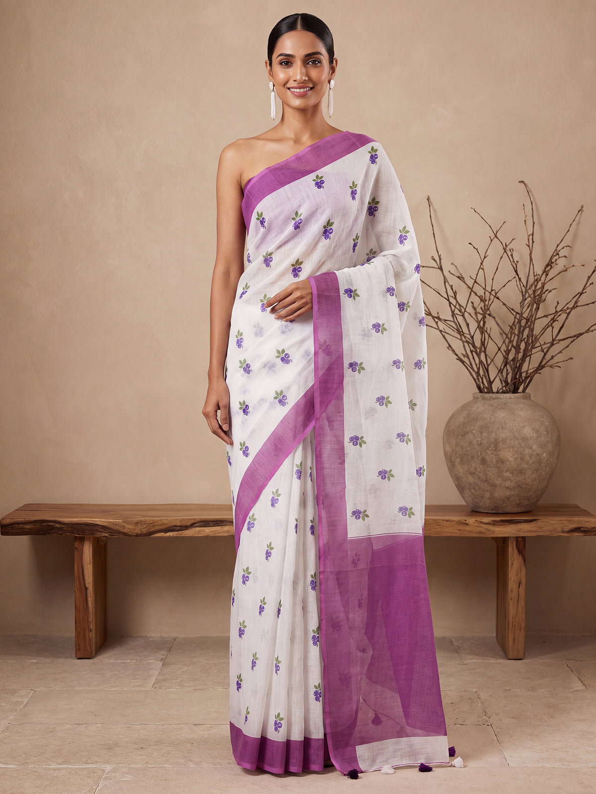 Woman wearing fuchsia cotton linen saree with quirky design and fuchsia blouse