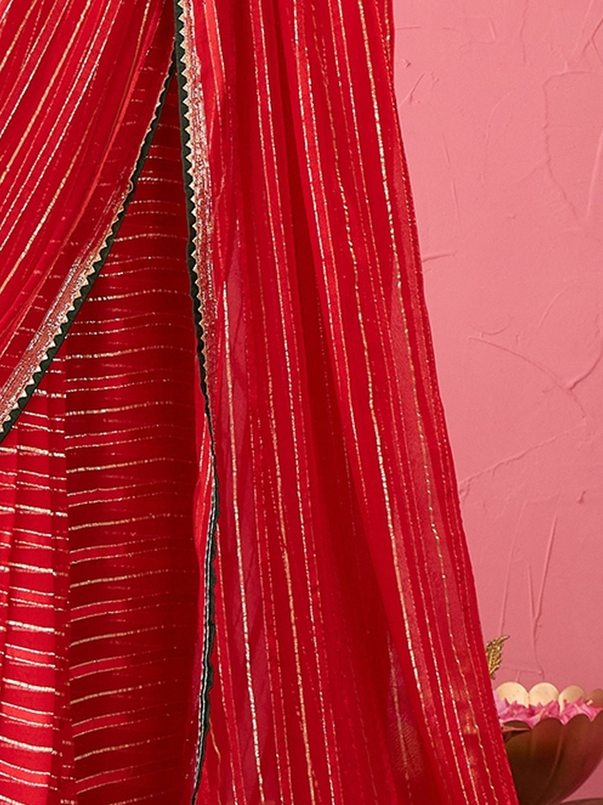 Pallu detail of red viscose saree showing striped pattern design and zari border