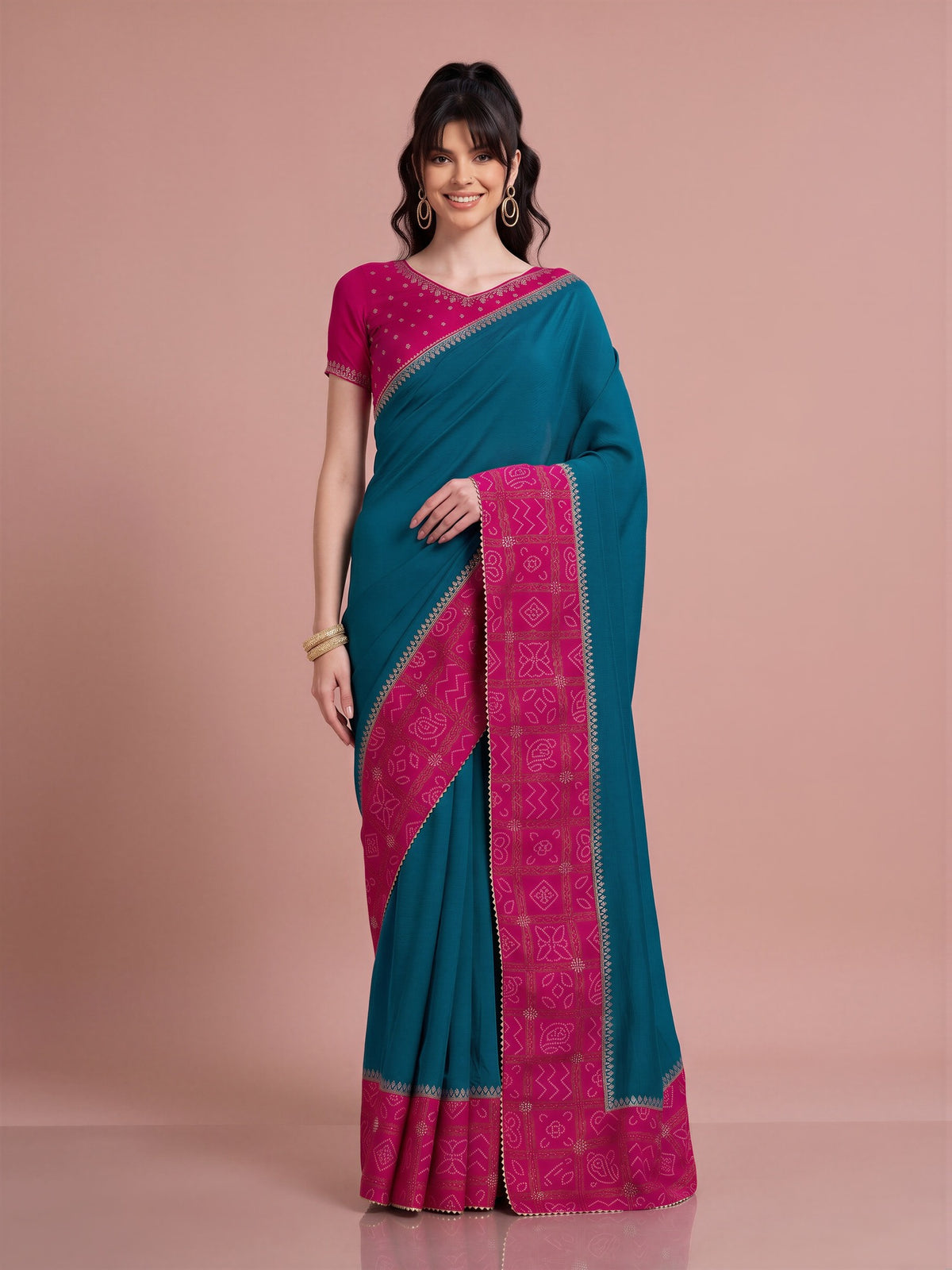 Woman wearing teal blue vichitra silk saree with bandhani tie-dye dot work and pink blouse